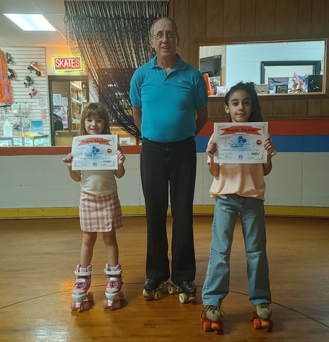 Lucy & Sashii Graduate Super Skater Level 1 with Coach John